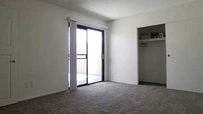 Broadway Apartments bedroom, closet, and balcony glass door